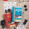 Three “Mixed-Media Stamp, Stencil, and Storybook Set European Scripts” kits by Schiffer Publishing, Ltd. feature foam stamps, stencils, and coins with European script accents on vintage papers. A red label reads: Collect Both Kits!.