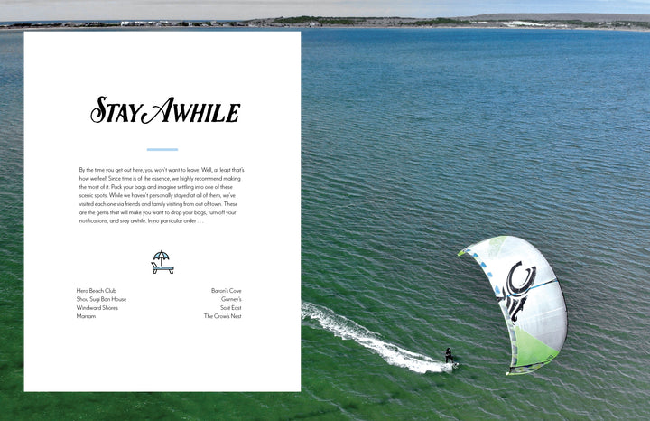 A kitesurfer glides across clear turquoise water near a sandy coastline on South Fork Long Island under a blue sky, with "Out East from Above" by Schiffer Publishing, Ltd. in elegant font and a white text box listing local destinations.