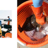 Someone wearing orange gloves holds a large flat fish in an ice-filled orange basket, while another in yellow overalls stands by fishing gear at the South Fork Long Island waterfront. From Out East from Above by Schiffer Publishing, Ltd.