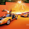 Two orange Mercedes-Benz C 111 models from Schiffer Publishing, Ltd. are displayed on an orange stage—one with its gullwing doors open, the other a sleek, futuristic coupe. The legendary sports car features a Wankel rotary engine.