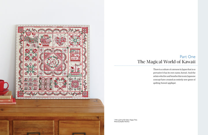 A red and white quilt featuring intricate, Japanese-inspired appliqué from "Kawaii Appliqué Quilts from Japan" by Schiffer Publishing, Ltd. is draped over a wooden chest. Nearby, text reads: “Part One: The Magical World of Kawaii.”.