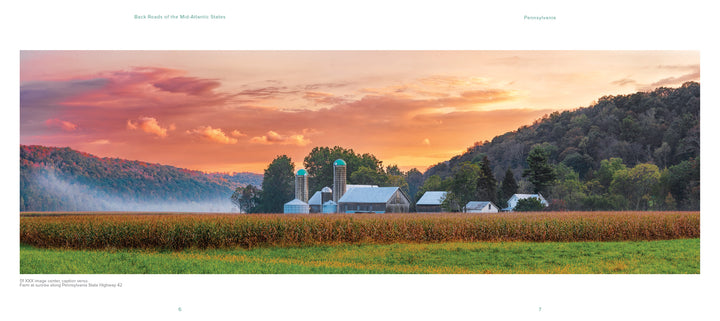 Capture the charm of Pennsylvania at sunset with "Back Roads of the Mid-Atlantic States" by Schiffer Publishing, Ltd.—featuring white barns, silos, lush crops, and tree-covered hills beneath a vivid sky in this picturesque landscape.