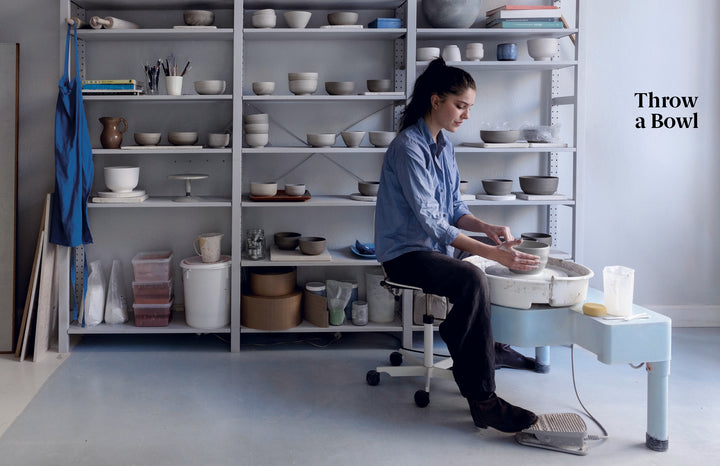 In a bright studio filled with ceramic bowls, a woman uses a pottery wheel. The text "Practical Pottery" from Schiffer Publishing, Ltd. appears, ideal for beginners seeking an essential pottery guide.
