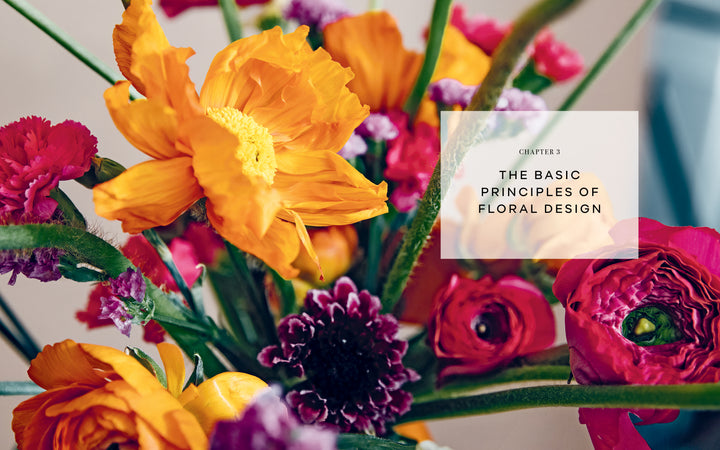 Close-up of a vibrant floral arrangement with orange, pink, yellow, and purple blooms. A white text box reads: "Chapter 3: The Basic Principles of Eco-Friendly Flower Arranging in Starting Your Floral Design Studio by Schiffer Publishing, Ltd.