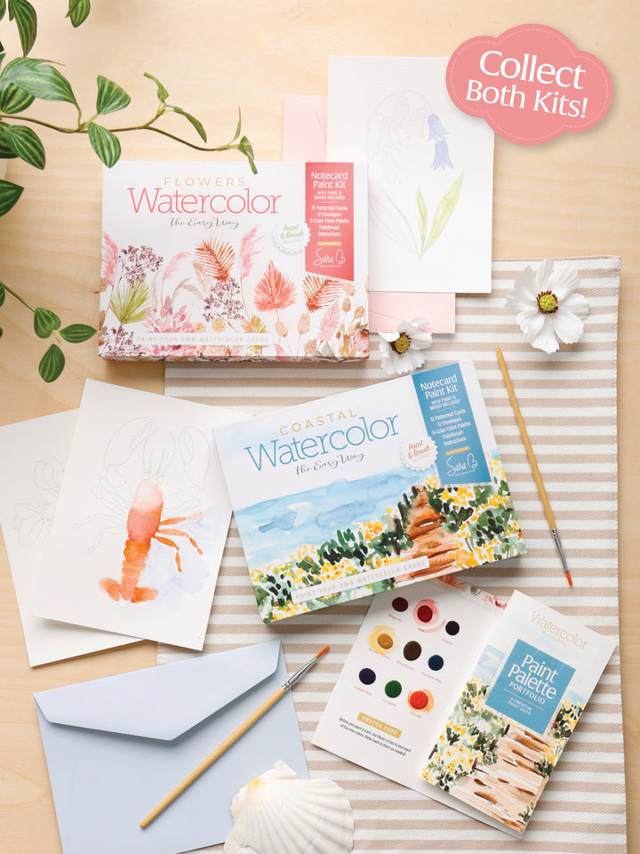 Schiffer Publishing, Ltd.'s Watercolor the Easy Way Paint-Your-Own Watercolor Cards Flowers kit is arranged on a light wooden surface with brushes, paper featuring floral designs, a striped cloth, plant, flower, notecards, and a blue envelope. "Collect Both Kits!" label shown.