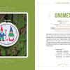 An embroidery hoop with two stitched gnomes—one blue, one green—hangs on a tree trunk beside a text page from "Monsters and Mayhem in Cross-Stitch" by Schiffer Publishing, Ltd., detailing gnome lore and cross-stitch patterns.