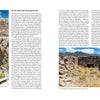 In Finding Nevada Wild by Schiffer Publishing, Ltd., a two-page spread features photos of stone ruins at Cherry Creek and the Pony Express Trail, including an image of someone entering a rocky structure and text detailing Nevada ghost towns’ history.