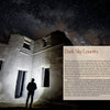 A person with a headlamp explores the stone ruins of a Nevada ghost town under the Milky Way, as featured in "Finding Nevada Wild" by Schiffer Publishing, Ltd., illustrating the chapter "Dark Sky Country.