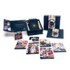 The Couture Tarot by Schiffer Publishing, Ltd. features fashion-inspired tarot cards with colorful illustrations, shown with an open and closed navy blue box adorned with gold accents and art deco designs.