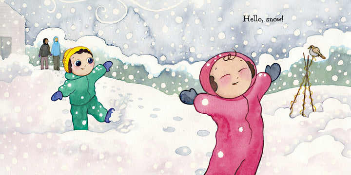 Two kids in bright snowsuits play in the snow with arms outstretched as two adults watch from a house nearby. Snow blankets the scene while a bird looks on. "Hello, Snow!" by Schiffer Publishing, Ltd. is the perfect winter sensory book.