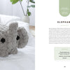 A plush gray crocheted elephant with black button eyes sits on a white bedspread near pillows. On the right, Schiffer Publishing's "Get Started in Finger Knitting" shows instructions and supplies for making the elephant with chunky yarn.