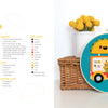 Felt Craft Fun by Schiffer Publishing, Ltd. features a colorful beginner embroidery hoop with a smiling taco atop a taco food truck and a cat inside, displayed against a wicker basket and yellow flowers on a white background.