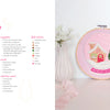 The book "Felt Craft Fun" by Schiffer Publishing, Ltd. features a pink felt snow globe embroidery with a house, tree, and snow on a hoop beside two pastel bottle brush trees, plus beginner-friendly step-by-step instructions and supply lists.