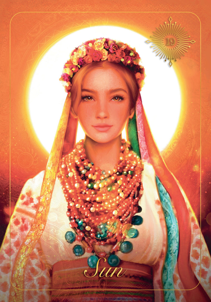 A woman in vibrant traditional dress with a floral crown and necklaces stands before a radiant sun, evoking Slavic heritage. "Sun" appears at the bottom, reflecting The Ukrainian Tarot by Schiffer Publishing, Ltd.