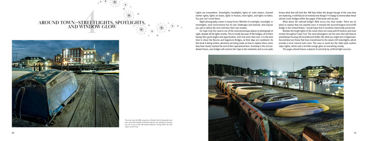 Two pages in Midnight on Cape Cod by Schiffer Publishing, Ltd. show a harbor at dusk: left—boats near old buildings aglow with streetlights; right—kayaks on a dock, sailboats, and water illuminated, evoking classic Cape Cod night scenes.