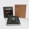 The Automobili Lamborghini Special Edition by Schiffer Publishing, Ltd. features a display with an illuminated car outline, a thick yellow-trimmed book, and a “Past Present Future” sleeve—ideal for luxury sportscar fans.
