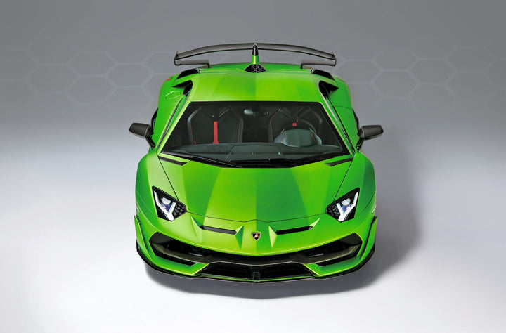 The Automobili Lamborghini Special Edition by Schiffer Publishing, Ltd. features a bright green sports car with sharp headlights, a large rear wing, and the sleek angular design signature to Lamborghini, set against a plain gray background.