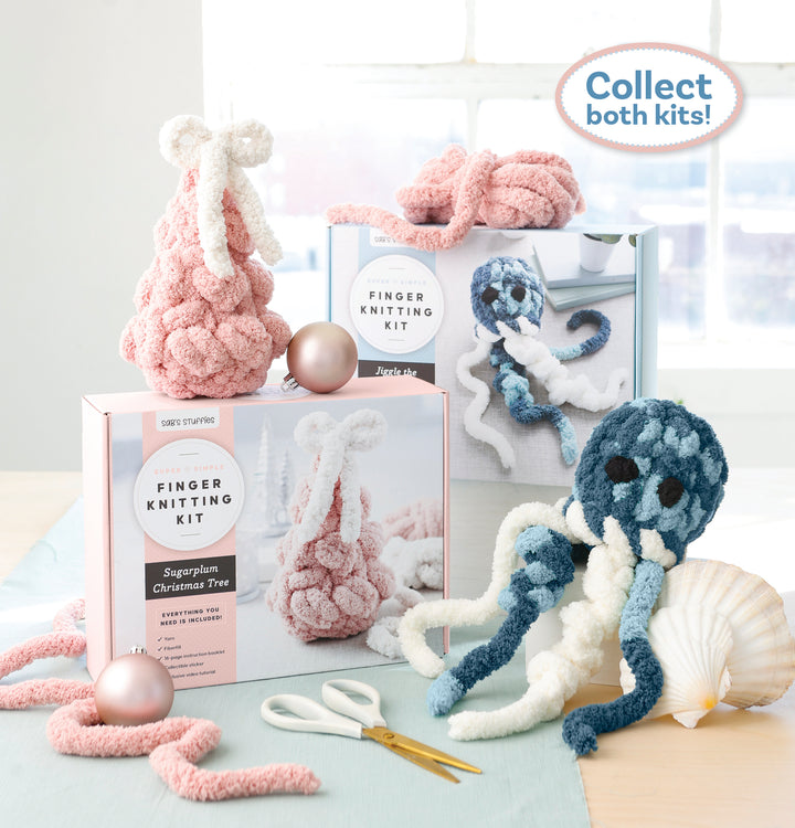 A Super Simple Finger Knitting Kit Jiggle the Jellyfish box by Schiffer Publishing, Ltd. and a blue jellyfish plush sit on a table with yarn, scissors, and ornaments. Text reads, “Collect both kits!”—great for beginner knitters.