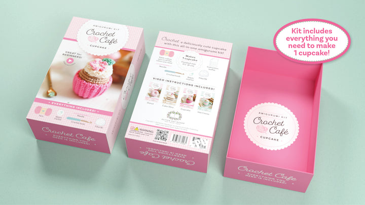 Three pink boxes labeled "Crochet Cafe Amigurumi Kit Cupcake" by Schiffer Publishing, Ltd. are shown. Each beginner kit includes all materials and instructions needed to crochet one cupcake, with a sample cupcake image on the box.