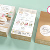 Three boxes of the Schiffer Publishing, Ltd. Crochet Cafe Amigurumi Kit Cake Slice are shown—two display front and back packaging, and one open reveals its contents. A pink sticker reads: Kit includes everything you need to make 1 cake slice!.