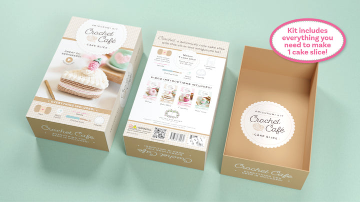 Three boxes of the Schiffer Publishing, Ltd. Crochet Cafe Amigurumi Kit Cake Slice are shown—two display front and back packaging, and one open reveals its contents. A pink sticker reads: Kit includes everything you need to make 1 cake slice!.