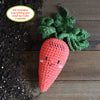 The Crochet Your Veggies Amigurumi Kit Carrot by Schiffer Publishing, Ltd. includes all you need to crochet a cute carrot with green leaves and a smiling face—perfect for beginners seeking an easy, fun crafting experience.