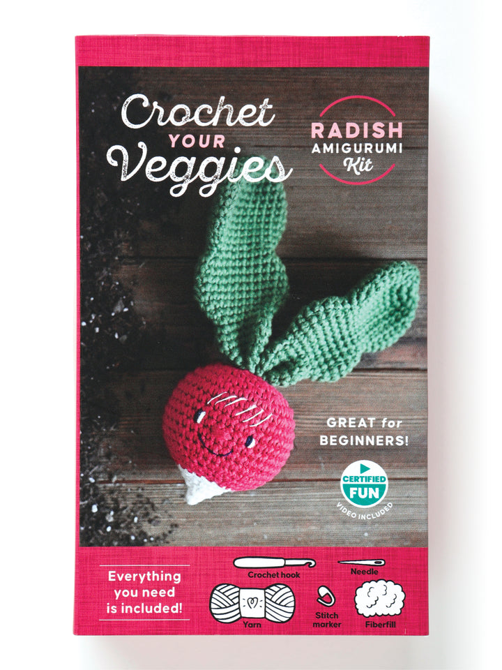 The Crochet Your Veggies Amigurumi Kit Radish by Schiffer Publishing, Ltd. features a cute radish design with green leaves and includes all supplies needed, making it a perfect beginner crochet kit.