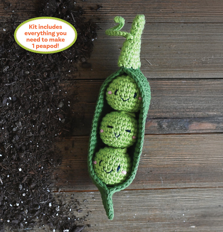 The Crochet Your Veggies Amigurumi Kit Peapod by Schiffer Publishing, Ltd. includes all supplies to make one green crocheted peapod with three smiling peas—perfect for beginner crocheters!.
