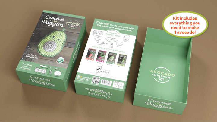Three views of the Schiffer Publishing, Ltd. Crochet Your Veggies Amigurumi Kit Avocado box—front, back, and inside—showing text that says this beginner kit includes supplies to create one avocado. Displayed on a light brown surface.