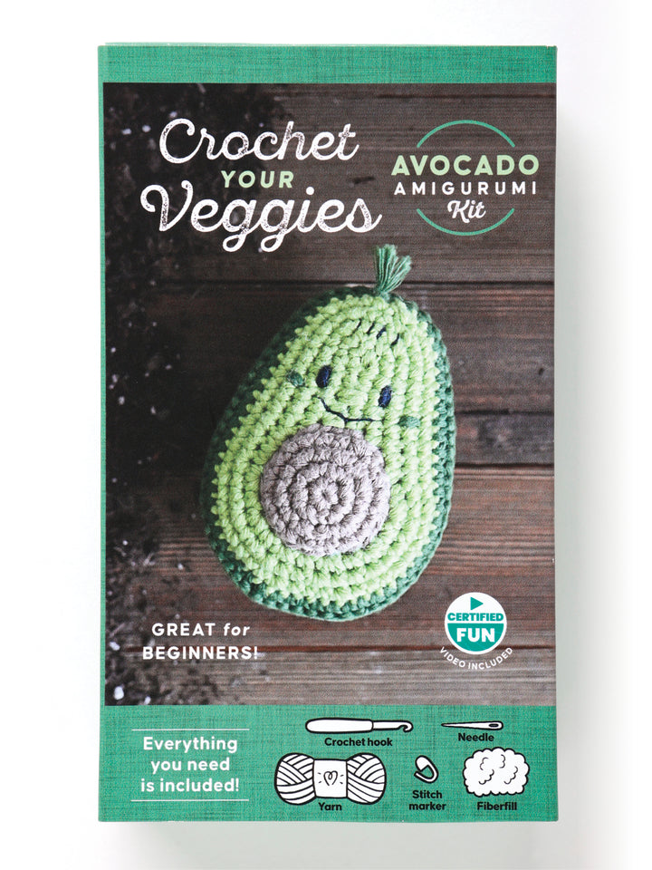 The Crochet Your Veggies Amigurumi Kit Avocado by Schiffer Publishing, Ltd. includes yarn, crochet hook, stitch marker, needle, and fiberfill—everything beginners need to crochet a cute smiling avocado. Perfect for crochet enthusiasts!.