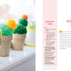 Handmade Happiness Yarn Crafts by Schiffer Publishing, Ltd. features three soft pom-pom cacti—yellow, green, and two-tone green—in small brown pots, each decorated with pins for a creative home décor accent.