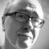 Black and white close-up photo of an older man with glasses, mustache, and goatee, gazing upward with a neutral expression. Light from the left highlights his face—he seems to ponder the mysteries of The Camelot Oracle by Schiffer Publishing, Ltd.