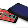 The Dark Daughter Tarot by Schiffer Publishing, Ltd. features the Three of Earth card face up, showing a colorful abstract figure with geometric patterns on a red background, while the rest of the deck remains stacked face down.
