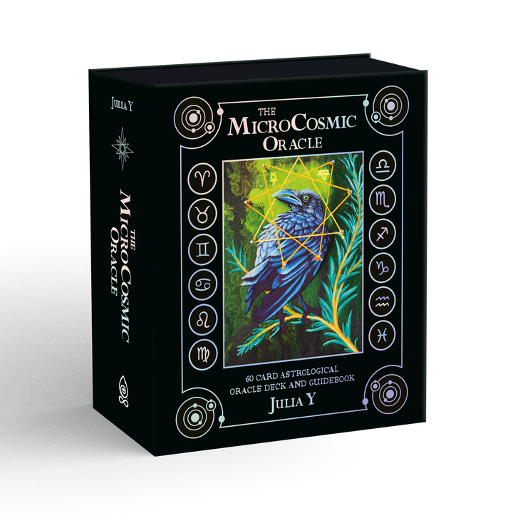 The MicroCosmic Oracle box by Schiffer Publishing, Ltd. features mystical symbols, astrological signs, and an illustrated raven among nature on a black background with colorful accents. Authored by Julia Y.