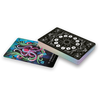 A stack of The MicroCosmic Oracle cards by Schiffer Publishing, Ltd. features intricate black and white geometric backs. One card is face up, revealing a vibrant abstract design with swirling shapes on a blue and green background.
