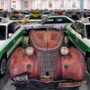 Audi's Historic Fleet by Schiffer Publishing, Ltd. showcases vintage and colorful cars, including white and green German police Audis flanking a rusty antique centerpiece.