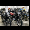 Audi's Historic Fleet by Schiffer Publishing, Ltd. showcases rows of vintage motorcycles in a bright indoor space, similar to displays at the Audi Museum Mobile, with close-up shots featuring classic red models.
