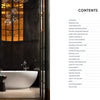 A freestanding white bathtub graces a luxurious bathroom with dark walls in this Midwest Home by Schiffer Publishing, Ltd., featuring a tall window, globe lights, side table, and a contents list shown on the next page.