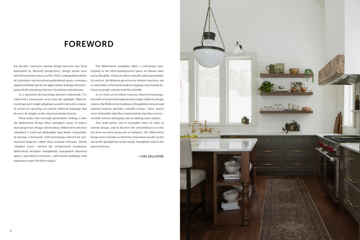 Inspired by Midwest Home from Schiffer Publishing, Ltd., this kitchen features dark cabinets, white countertops, a farmhouse sink, open wood shelves, a patterned rug on dark wood floors, large windows for natural light, and a pendant above the island.