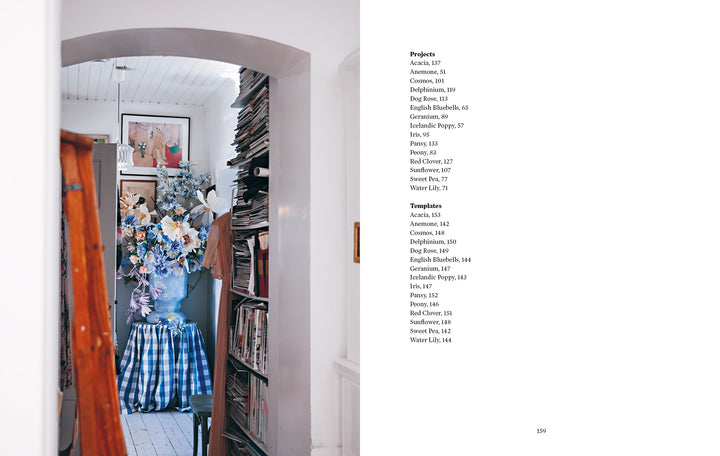 A narrow, cozy room features stacked books, a bouquet of crepe-paper blooms made with Paper Flower Magic by Schiffer Publishing, Ltd. on a blue gingham table, framed art on white walls, and a project/template index on the right.