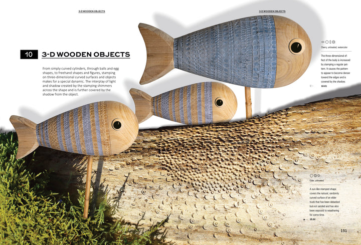 Stamping on Wood by Schiffer Publishing, Ltd. showcases three wooden fish sculptures with blue stripes and stamped wood tails, displayed on rods above bark and greenery as sunlight casts artistic shadows.