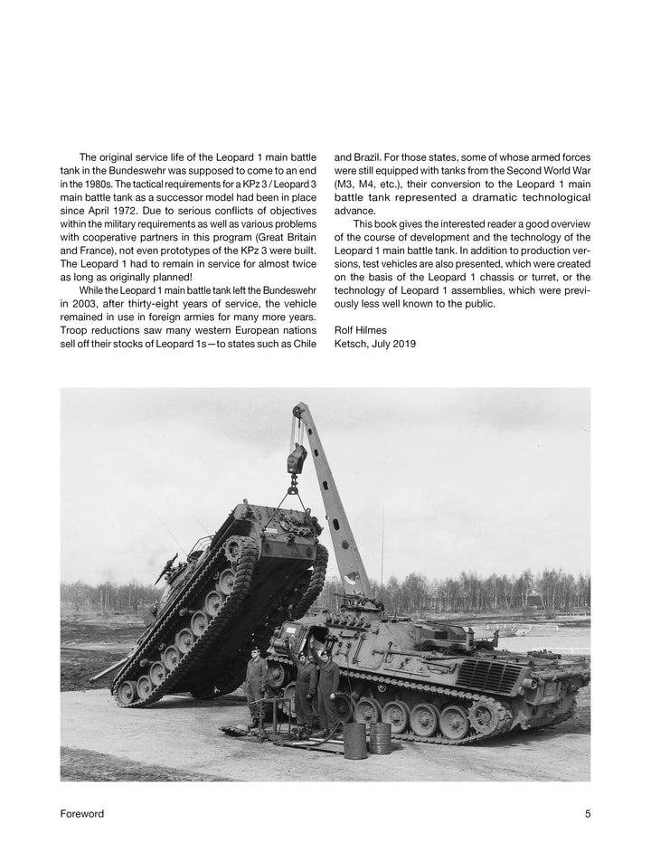 A crane lifts the turret off a Schiffer Publishing, Ltd. Leopard 1 as crew supervise. Nearby, another tank and a truck are visible on the paved outdoor area.