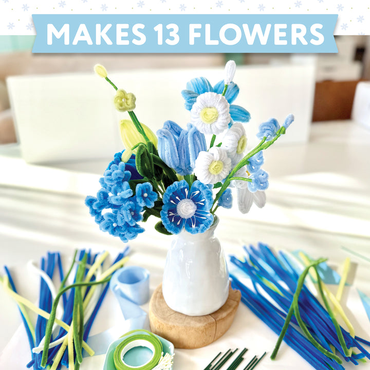 The Bendable Blooms Chenille Stem Flower-Making Kit Botanical Blues by Schiffer Publishing, Ltd. lets you create 13 blue, white, and yellow pipe cleaner flowers in a white vase—perfect for DIY creative fun! Text reads: MAKES 13 FLOWERS.