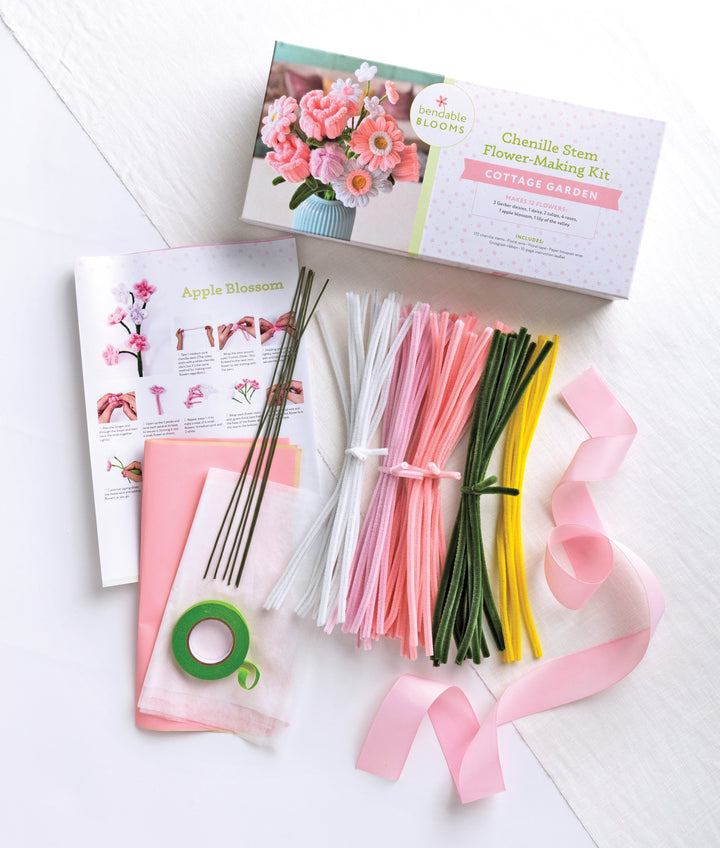 The Bendable Blooms Chenille Stem Flower-Making Kit Cottage Garden by Schiffer Publishing, Ltd. includes pink, white, yellow, and green stems, floral tape, ribbons, wires, tissue paper, instructions, and a box for DIY bouquets or craft flowers.