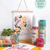 The ColorMaps Paint-by-Number Beautiful Blooms kit by Schiffer Publishing, Ltd. includes paint pots, brushes in a jar, a small plant, and rolled kit tubes. A completed artwork hangs above with a “Collect Both Kits!” circle—great for beginner painters.