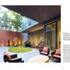 Patio Living by Schiffer Publishing, Ltd. showcases a modern courtyard with seating, hanging chairs, potted plants, sculpture, and grass lawn. Glass walls create an open indoor-outdoor vibe and a relaxing space among the trees.