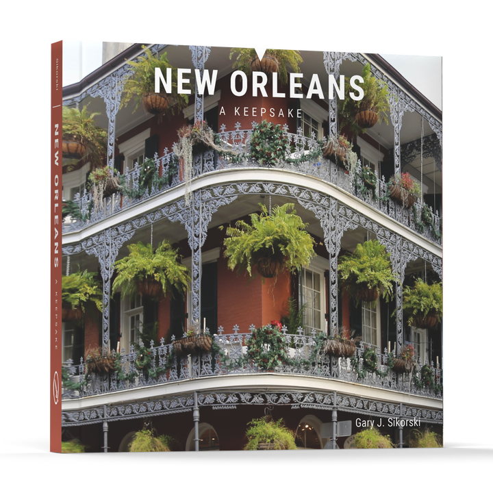 The cover of New Orleans by Schiffer Publishing, Ltd. displays a historic building adorned with ornate iron balconies and lush hanging plants.