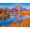 Grand Teton National Park by Schiffer Publishing, Ltd. showcases Oxbow Bend’s calm waters reflecting autumn trees and the Grand Teton mountain range beneath a blue sky—an iconic scene for any photography lover.