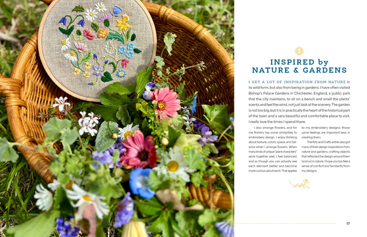 A wicker basket of colorful flowers sits on grass, holding "Wild Embroidery" from Schiffer Publishing, Ltd., which features nature embroidery designs that echo the blooms. A page about nature and garden inspiration lies to the right.