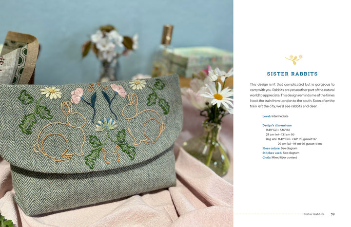 Wild Embroidery by Schiffer Publishing, Ltd. features a textured clutch with Arts and Crafts embroidery of two rabbits and flowers, shown on a pink cloth beside daisies, a teacup, a book, and a visible project description.